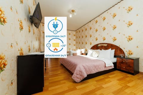 Communal lounge/ TV room, Bed, Property logo or sign, TV and multimedia, Photo of the whole room, Evening entertainment, Logo/Certificate/Sign, Bedroom, Text overlay, Certificate/Award