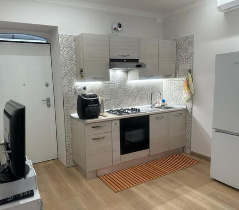 Kitchen or kitchenette, dishwasher, oven, stove