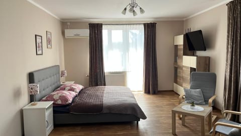 Bed, TV and multimedia, Living room, Seating area, air conditioner