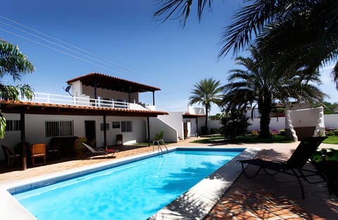 Property building, Patio, Pool view, Swimming pool, sunbed