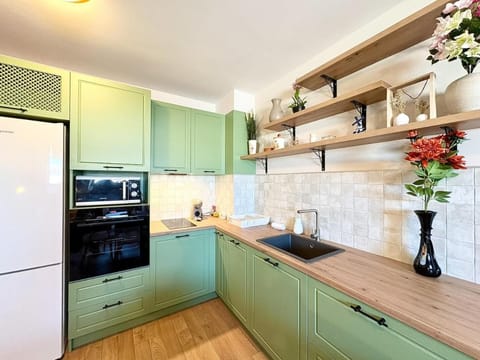 Kitchen or kitchenette, dishwasher, microwave, oven, stove