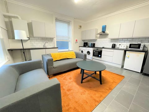 Kitchen or kitchenette, Living room, Dining area, oven, stove, toaster, washing machine, dryer