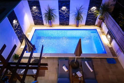 Patio, Night, Pool view, Swimming pool, sunbed