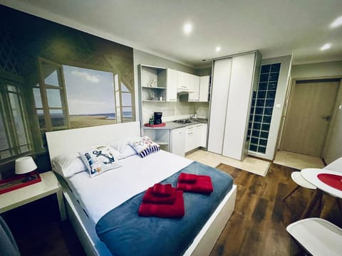 Bed, Kitchen or kitchenette, towels, wardrobe