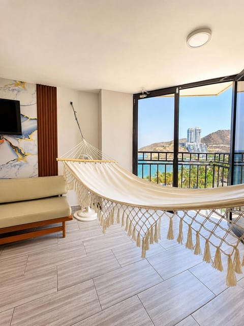 Communal lounge/ TV room, Natural landscape, TV and multimedia, View (from property/room), Balcony/Terrace, Living room, Seating area, Beach, Evening entertainment, Sea view