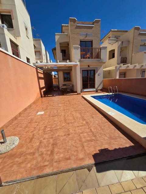 Property building, Patio, Pool view, Swimming pool, sunbed