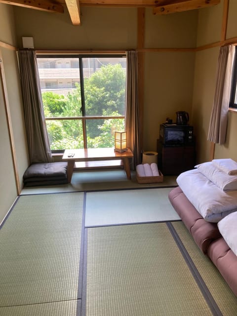 Photo of the whole room, microwave, towels, air conditioner