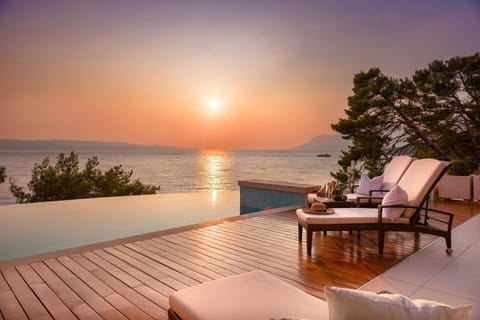 Property building, Patio, Day, Natural landscape, Summer, View (from property/room), Balcony/Terrace, Balcony/Terrace, Living room, Seating area, Beach, Pool view, Sea view, Swimming pool, Swimming pool, Sunset, sunbed