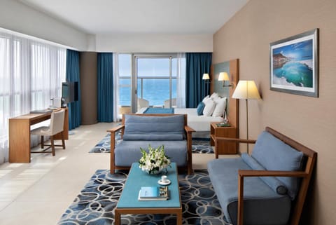 Bed, TV and multimedia, Living room, Seating area, Bedroom