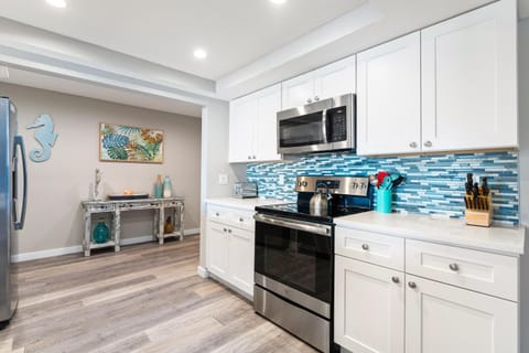 Kitchen or kitchenette, dishwasher, oven, stove