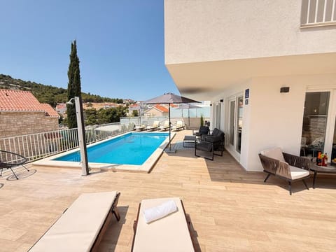 Property building, Patio, Natural landscape, Seating area, Pool view, Swimming pool, sunbed