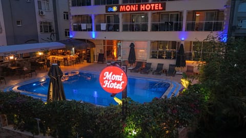 Property building, Communal lounge/ TV room, Night, Property logo or sign, Evening entertainment, Pool view, Swimming pool