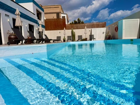 Property building, Day, Pool view, Swimming pool, sunbed