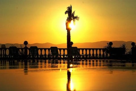 Property building, Off site, Natural landscape, Beach, On site, Text overlay, Pool view, Sea view, Swimming pool, Swimming pool, Sunrise, Sunset