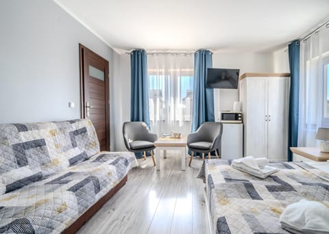 Bed, TV and multimedia, Seating area, microwave, wardrobe