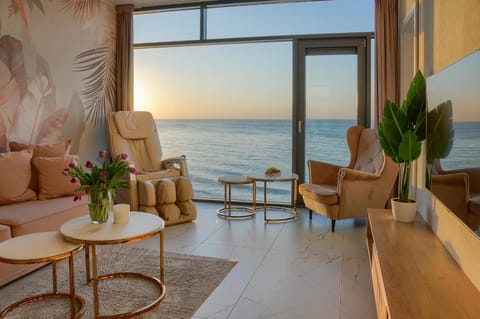 Day, View (from property/room), Living room, Seating area, Sea view, Sunset