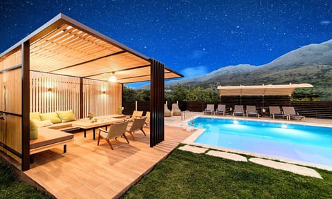 Property building, Patio, Night, Natural landscape, Dining area, Mountain view, Pool view, Swimming pool, sunbed