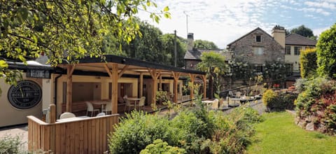 Property building, Patio, Restaurant/places to eat, Facade/entrance, Property logo or sign, Garden, Garden view