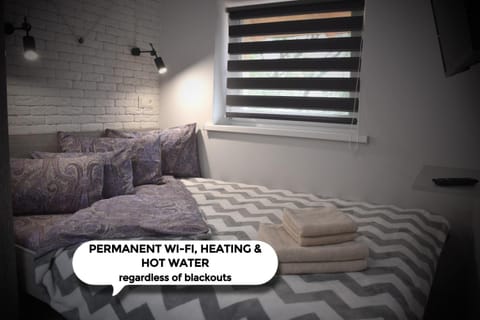 Bed, Photo of the whole room, Bedroom, Text overlay, towels