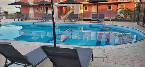Property building, Day, Pool view, Swimming pool, sunbed