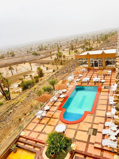 Property building, Patio, Restaurant/places to eat, Natural landscape, Pool view, Swimming pool