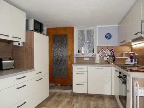 Kitchen or kitchenette, dishwasher, oven, stove