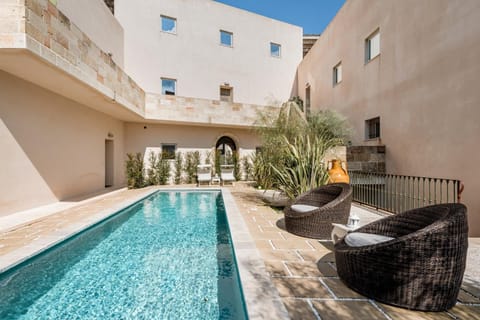 Property building, Patio, Day, Living room, Seating area, Pool view, Swimming pool, sunbed