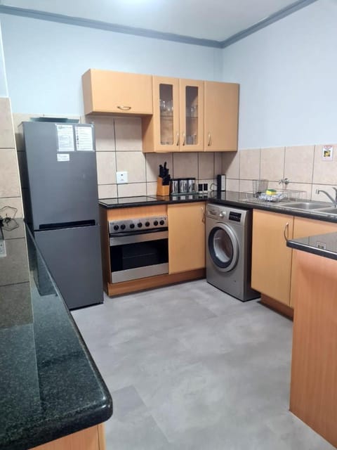Kitchen or kitchenette, microwave, stove, washing machine