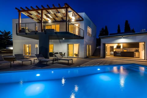 Property building, Patio, Night, Swimming pool, sunbed