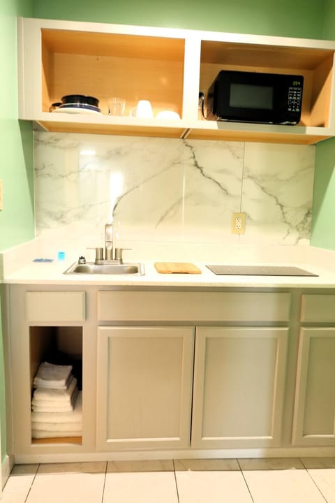 Kitchen or kitchenette, microwave, stove, towels, kitchen