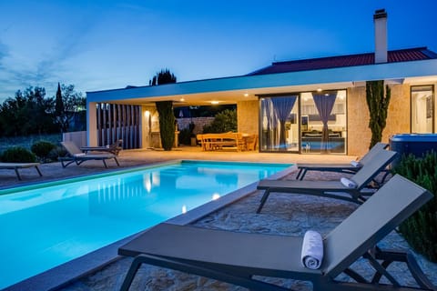Property building, Patio, Night, Swimming pool, sunbed
