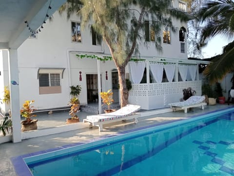 Property building, Patio, Pool view, Swimming pool, sunbed