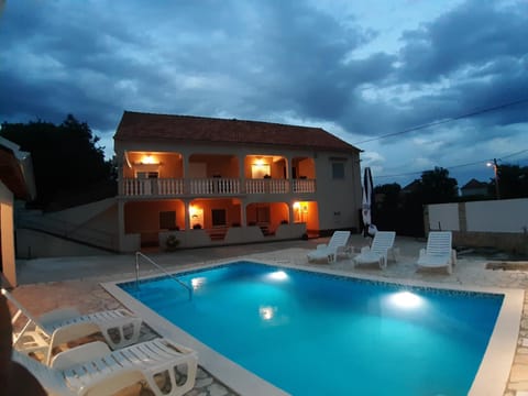 Property building, Facade/entrance, Pool view, Swimming pool, Swimming pool, Sunset