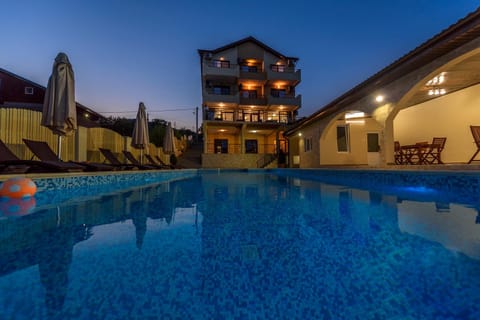 Property building, Night, Pool view, Swimming pool, sunbed