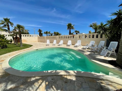 Property building, Patio, Day, Natural landscape, Pool view, Swimming pool, Swimming pool, sunbed