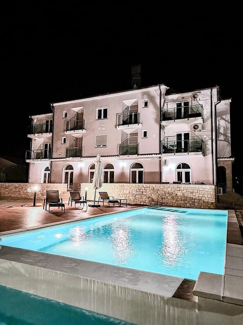 Property building, Patio, Night, Swimming pool, sunbed