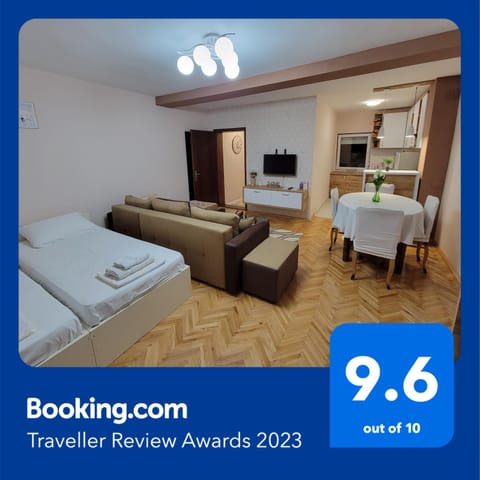 Communal lounge/ TV room, Bed, TV and multimedia, Kitchen or kitchenette, Living room, Photo of the whole room, Seating area, Dining area, Evening entertainment, Bedroom, Text overlay, Certificate/Award