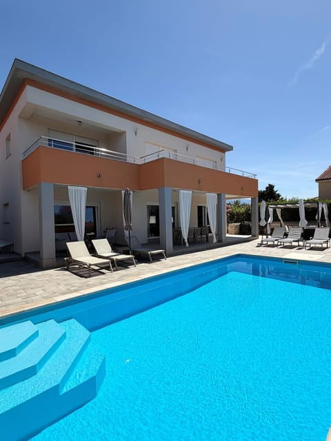 Property building, Patio, Pool view, Swimming pool, sunbed