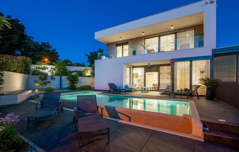 Property building, Patio, Night, Swimming pool, sunbed