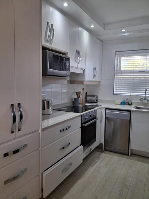 Kitchen or kitchenette, dishwasher, oven, stove, toaster