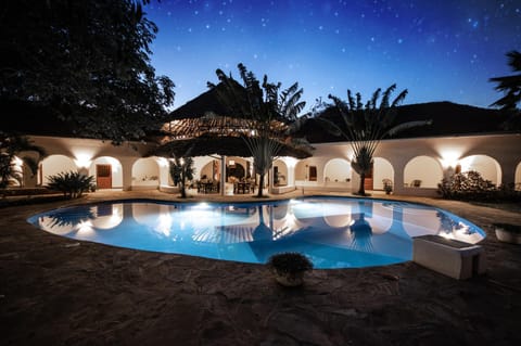 Property building, Patio, Night, Balcony/Terrace, Dining area, Pool view, Swimming pool