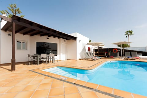 Property building, Patio, Pool view, Swimming pool, sunbed