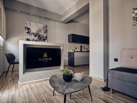 Property logo or sign, TV and multimedia, Kitchen or kitchenette, Living room, Dining area