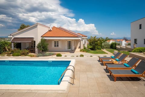 Property building, Patio, Day, Natural landscape, Seating area, Pool view, Swimming pool