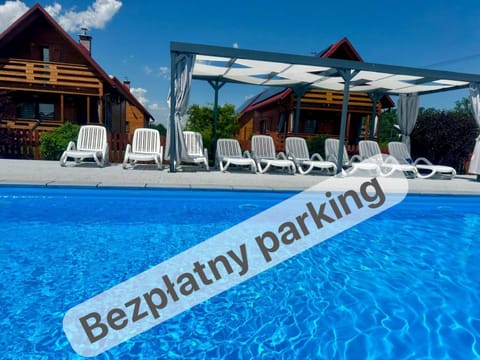Day, Property logo or sign, Swimming pool, sunbed