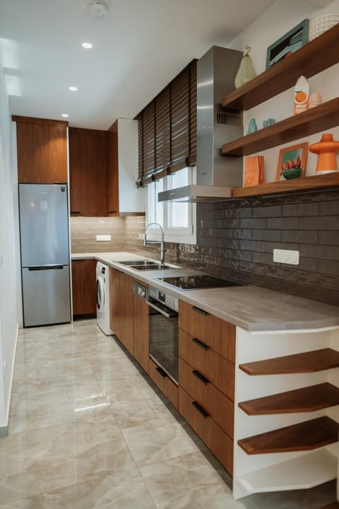 Kitchen or kitchenette, dishwasher, oven, stove