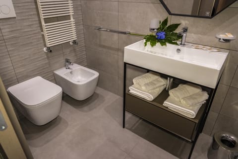 Toilet, Bathroom, bidet, hair dryier, towels