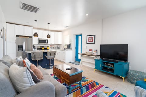 TV and multimedia, Kitchen or kitchenette, Living room, Seating area, furniture, microwave, kitchen, air conditioner