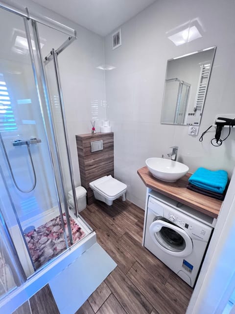 Shower, Toilet, Bathroom, towels, washing machine, dryer