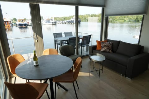 View (from property/room), Living room, Seating area, Dining area, Lake view